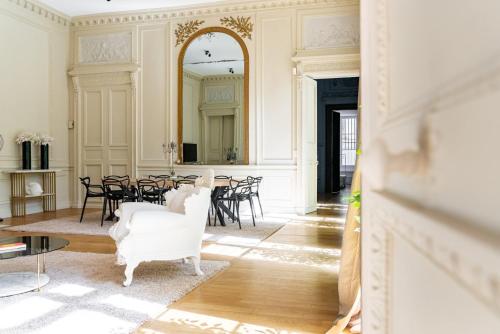 Cette chambre comprend une table, des chaises et un miroir. dans l'établissement Chambellan des Ducs - caractère et central, à Dijon