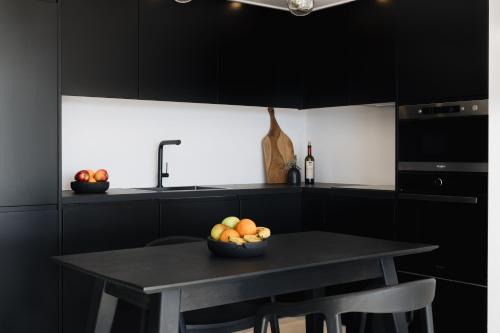 a kitchen with a table with a bowl of fruit on it at Luzazul 2 bed apartment with jacuzzi and sea view in Paleros