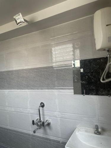 a bathroom with a sink and a mirror on the wall at Hotel Kapish International Solapur 400 mts from Bus Stand and 500 mtr from railway station in Solapur