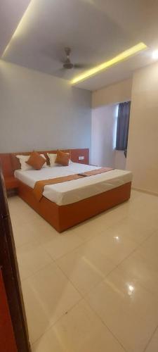 a bedroom with a large bed in a room at Hotel Kapish International Solapur 400 mts from Bus Stand and 500 mtr from railway station in Solapur