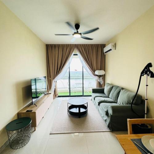 a living room with a couch and a ceiling fan at Seaview 2B1R 4 pax Condo Forest City 1G-2908 in Gelang Patah