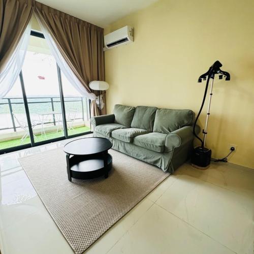 a living room with a couch and a table at Seaview 2B1R 4 pax Condo Forest City 1G-2908 in Gelang Patah