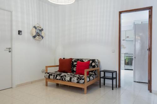 a living room with a bench with pillows on it at BLife Martinya house - private rooms and apartments in Olhão
