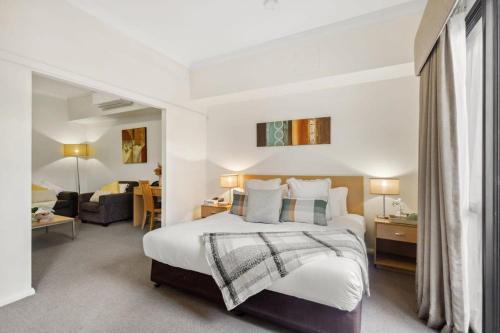 a bedroom with a bed and a living room at Perth Premium 1 Bedroom in Perth