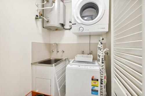 a small kitchen with a washing machine and a sink at Perth Premium 1 Bedroom in Perth