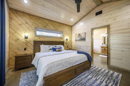 a bedroom with a bed in a wooden cabin at Morning Roast Cabin in Broken Bow