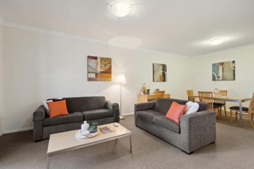 a living room with two couches and a table at 2BDR 1BTH 1PRK - Northbridge Magic in Perth