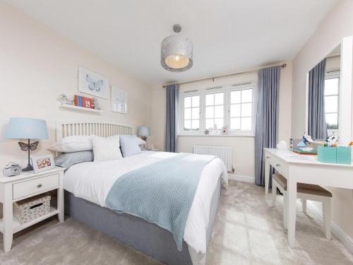 a white bedroom with a bed and a desk at 3 Bedroom, 3.5 Bathroom House, Goodwood Racecourse in Lavant