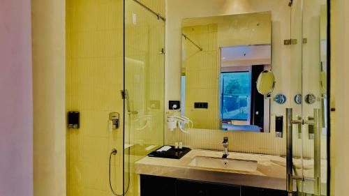 a bathroom with a sink and a shower at Vintclub Resort in Lucknow