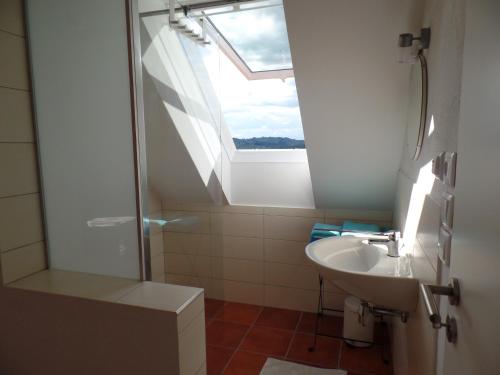 a bathroom with a sink and a window in it at Holiday Home Sonnenhaus in Svečina