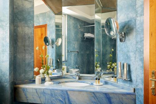 a bathroom with a sink and a mirror at Hotel Panorama in Thessaloniki