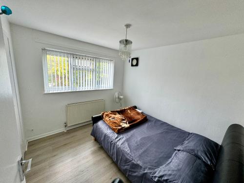 a bedroom with a bed with a pillow on it at Cozy Home in Twickenham