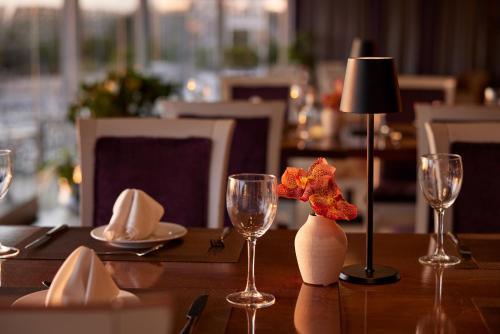 a table with wine glasses and a lamp on it at Hotel Panorama in Thessaloniki