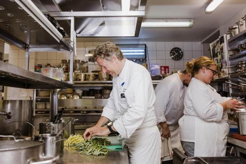 a group of people in a kitchen preparing food at Hotel Geerts in Westerlo
