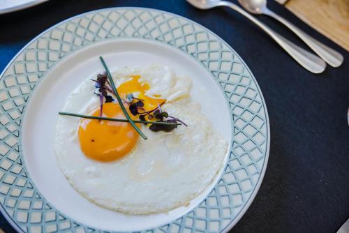 a white plate with food on a table at Hotel Geerts in Westerlo