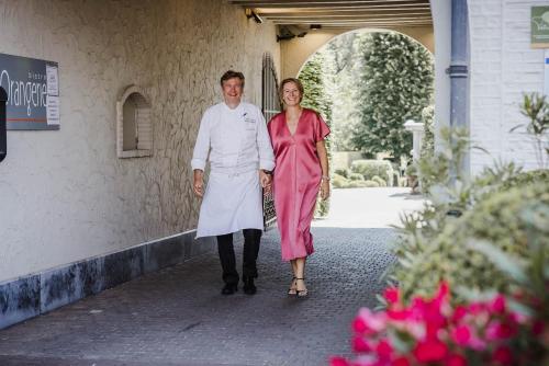 a man and a woman walking down a sidewalk at Hotel Geerts in Westerlo