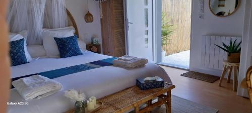 a bedroom with a large bed with towels on it at "Chez Lyly et Juju" Piscine&Calme 3Chambres in Angers