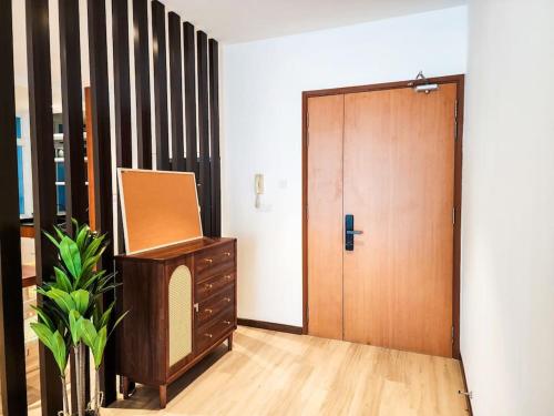 a room with a wooden door and a wooden floor at Railway Stylish Homestay (3BR3B) 6pax by Cowidea in Johor Bahru