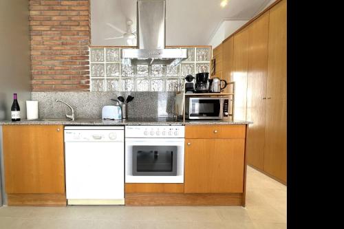 a kitchen with a white oven and a microwave at Loft with terrace in Tossa in Tossa de Mar