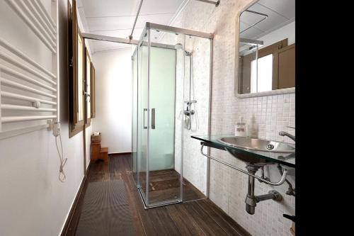 a bathroom with a glass shower and a sink at Loft with terrace in Tossa in Tossa de Mar