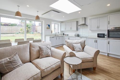 a living room with a couch and chairs and a table at Host & Stay - Emilyn House in Whitburn