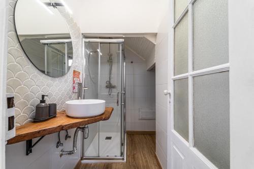 a bathroom with a sink and a mirror at Lost Lobster Guest House in Albufeira