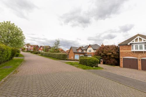 a brick road in a residential neighborhood with houses at Supreme Class Properties in Eastchurch