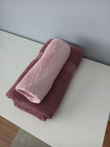 a pink towel sitting on a counter next to a mirror at Citykoti in Varkaus