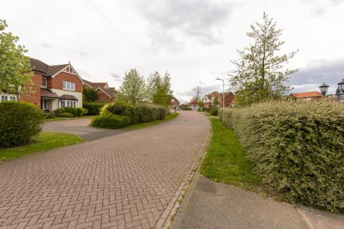 a brick road in a residential neighborhood with houses at Supreme Class Properties in Eastchurch