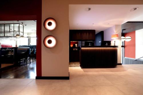 a restaurant with a bar with vases on the wall at Best Western Plus Hotel St. Raphael in Hamburg