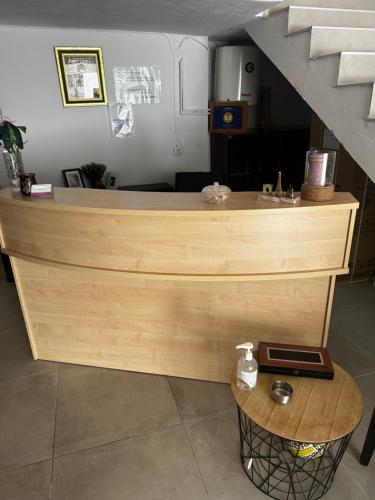 a wooden counter with a table next to a staircase at Pansion Angela in Skiathos Town