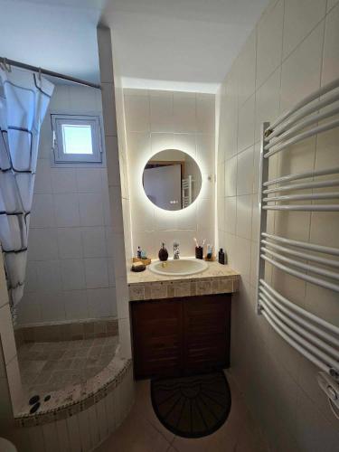 une salle de bain avec un lavabo, une douche et un miroir dans l'établissement Studio Calista - Quartier Naturiste Cap d'Agde, au Cap d'Agde