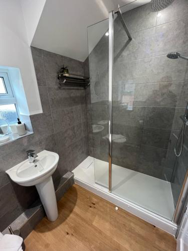 a bathroom with a shower and a sink at Pass the Keys Cosy flat close to metro City and hospitals in Gosforth