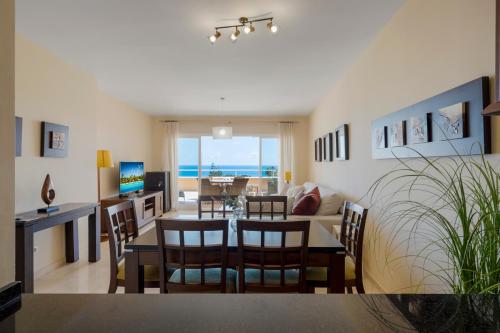 a dining room and living room with a table and chairs at Malibu B3 Luxury 2BR Panoramic Sea View Ref 245 in Fuengirola