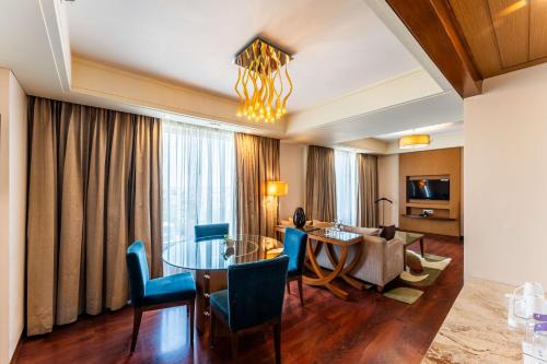 a living room with a table and chairs and a living room at Radisson Blu Hotel, Indore in Indore
