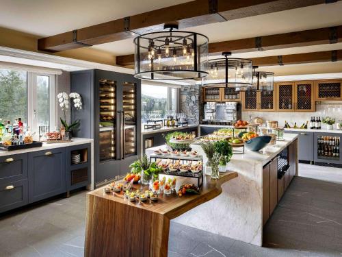a kitchen with a counter with fruits and vegetables on it at Fairmont Chateau Whistler in Whistler