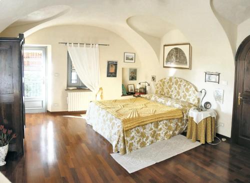 a bedroom with a bed and a table in it at 2 bedrooms apartement with enclosed garden at Carru in Carrù