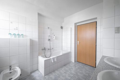a bathroom with a tub and a toilet and a sink at City inn Olomouc in Olomouc