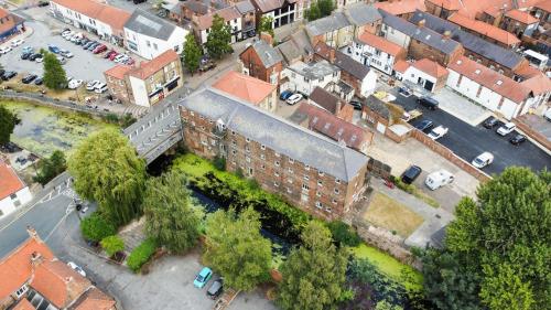 an overhead view of a city with buildings and trees at Riverside Mews in Brigg