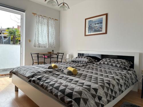 a bedroom with a large bed with two pillows on it at Rooms MARE in Poreč