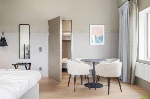 a bedroom with a bed and a table and chairs at Aiden by Best Western Karlstad Arena in Karlstad