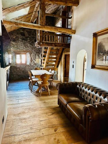 a living room with a couch and a table at Chasa Veglia in Sent