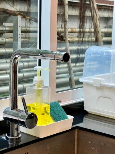 a kitchen sink with a faucet with yellow liquid at Entire 3BR Townhome, Pool, Sukhumvit, BTS&MRT Asok in Bangkok
