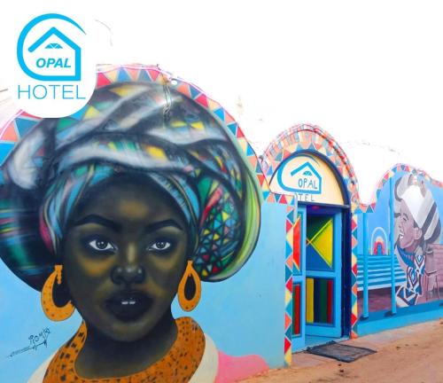 a mural of a woman in front of a building at Opal privat nubian hotel in Aswan