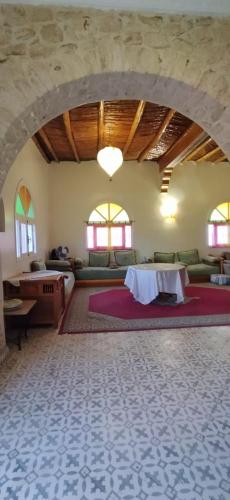 a large living room with a table and a couch at Villa chez NADA in Essaouira