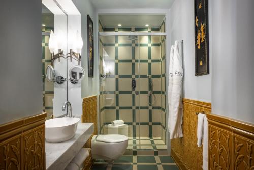 a bathroom with a toilet and a sink and a shower at Hotel Number Nine in Florence