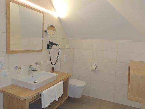 a bathroom with a sink and a toilet and a mirror at Haus Christophorus in Obergurgl