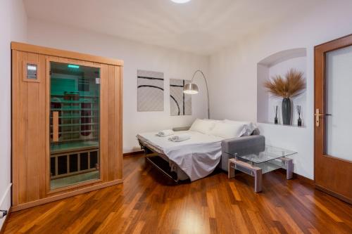 a bedroom with a bed and a table in it at Casa Rufino, Sauna e Cromoterapia in Assisi