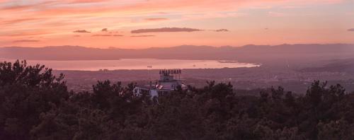 a building on a hill with a view of a lake at Hotel Panorama in Thessaloniki