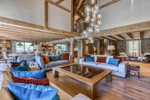a living room with couches and a table at Chalet Charvin in Megève